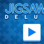 파란 배경 위에 퍼즐 조각 이미지와 큰 재생 버튼이 있는 Jigsaw Deluxe 텍스트