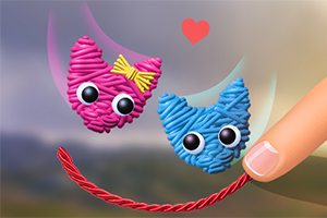 핑크색과 파란색 실뭉치 고양이 얼굴 두 개가 붉은 하트를 배경으로 둥둥 떠 있으며 손가락이 빨간 실을 잡고 있다