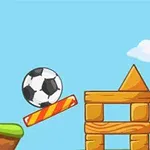 푸른 하늘 아래 축구 공이 경사로와 나무 블록 옆에 있는 축구 골대를 향하고 있는 장면